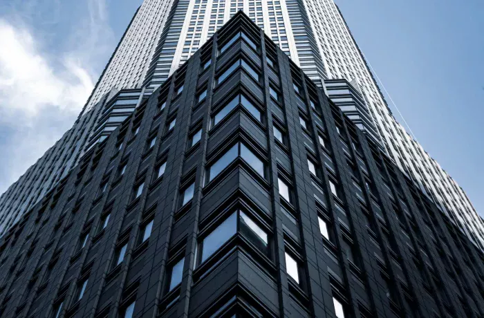 low-angle-shot-tall-city-building-with-blue-sky-background-new-york